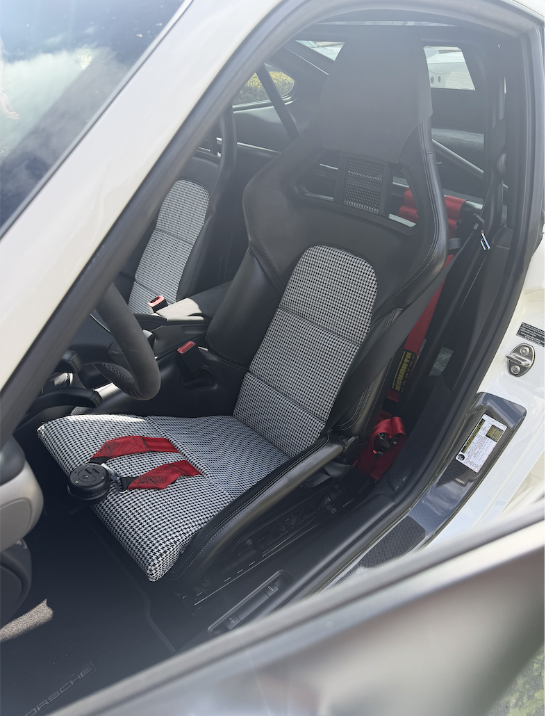 Porsche 991 GT3 driver seat with houndstooth centers and red Schroth harness
