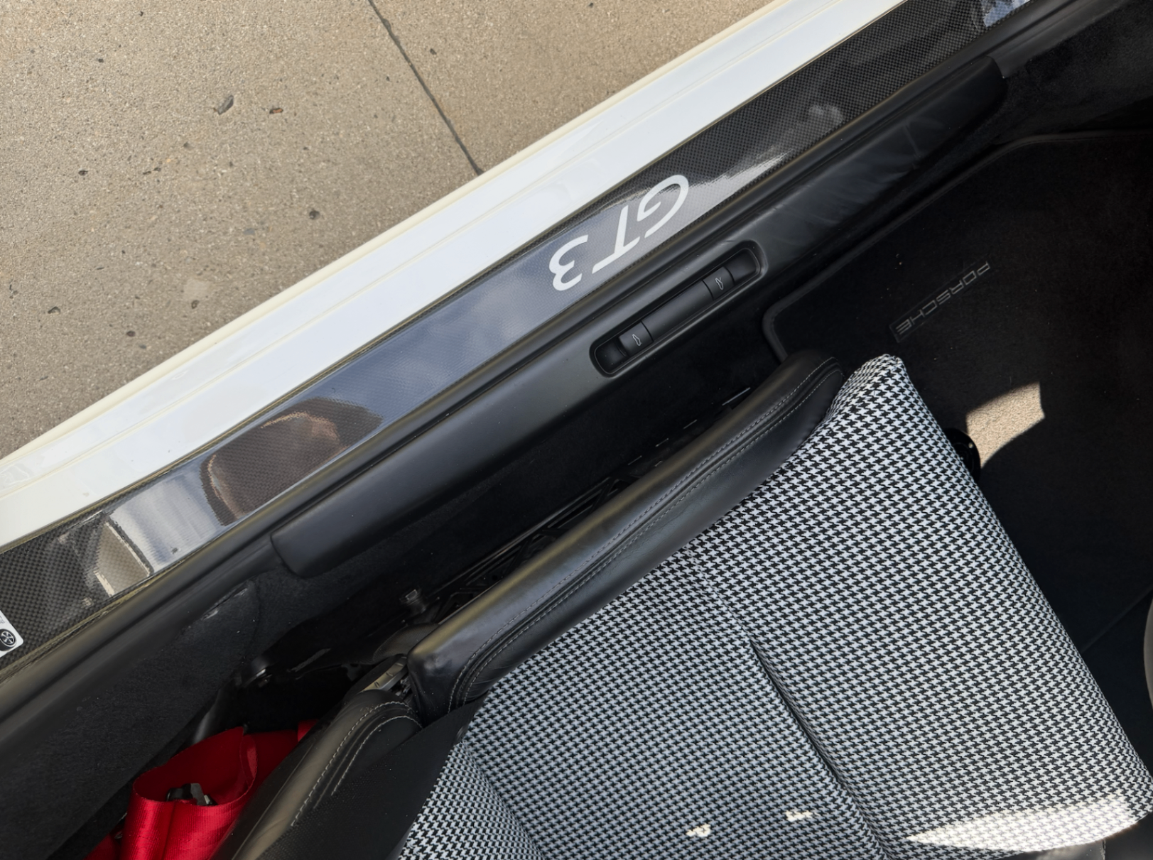 Porsche GT3 carbon sill plate with houndstooth seat edge visible