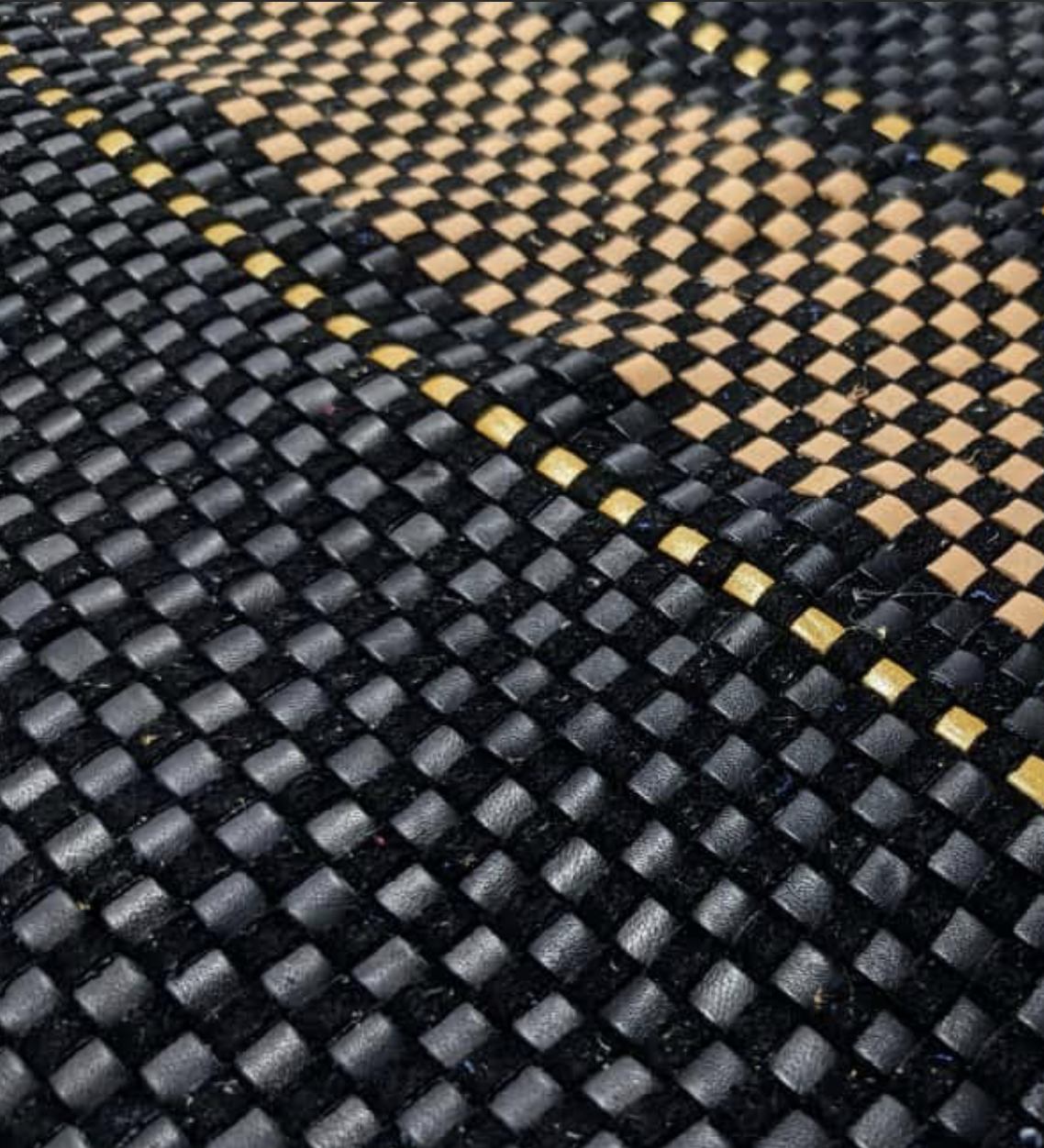 Hand-woven black leather with tan and gold accent stripes