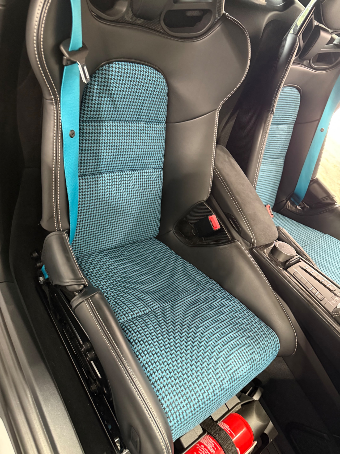 Porsche 718 GT4 bucket seat re-trimmed with Miami Blue houndstooth inserts and black leather bolsters