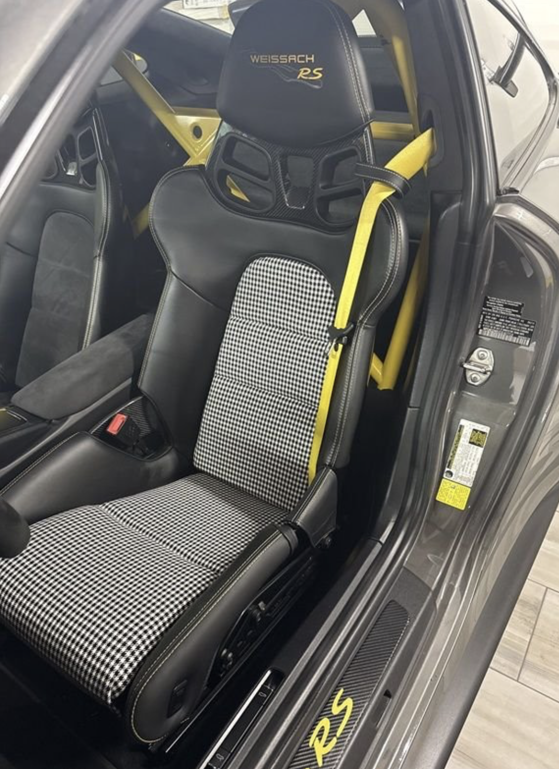 Porsche GT3 RS Weissach carbon bucket seat with black-and-white houndstooth insert and yellow harness