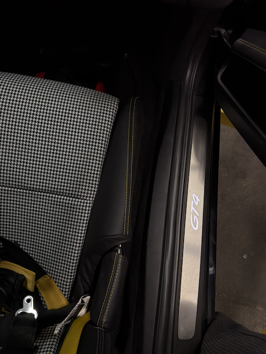 Black bolster protector with contrast stitching on a Porsche bucket seat