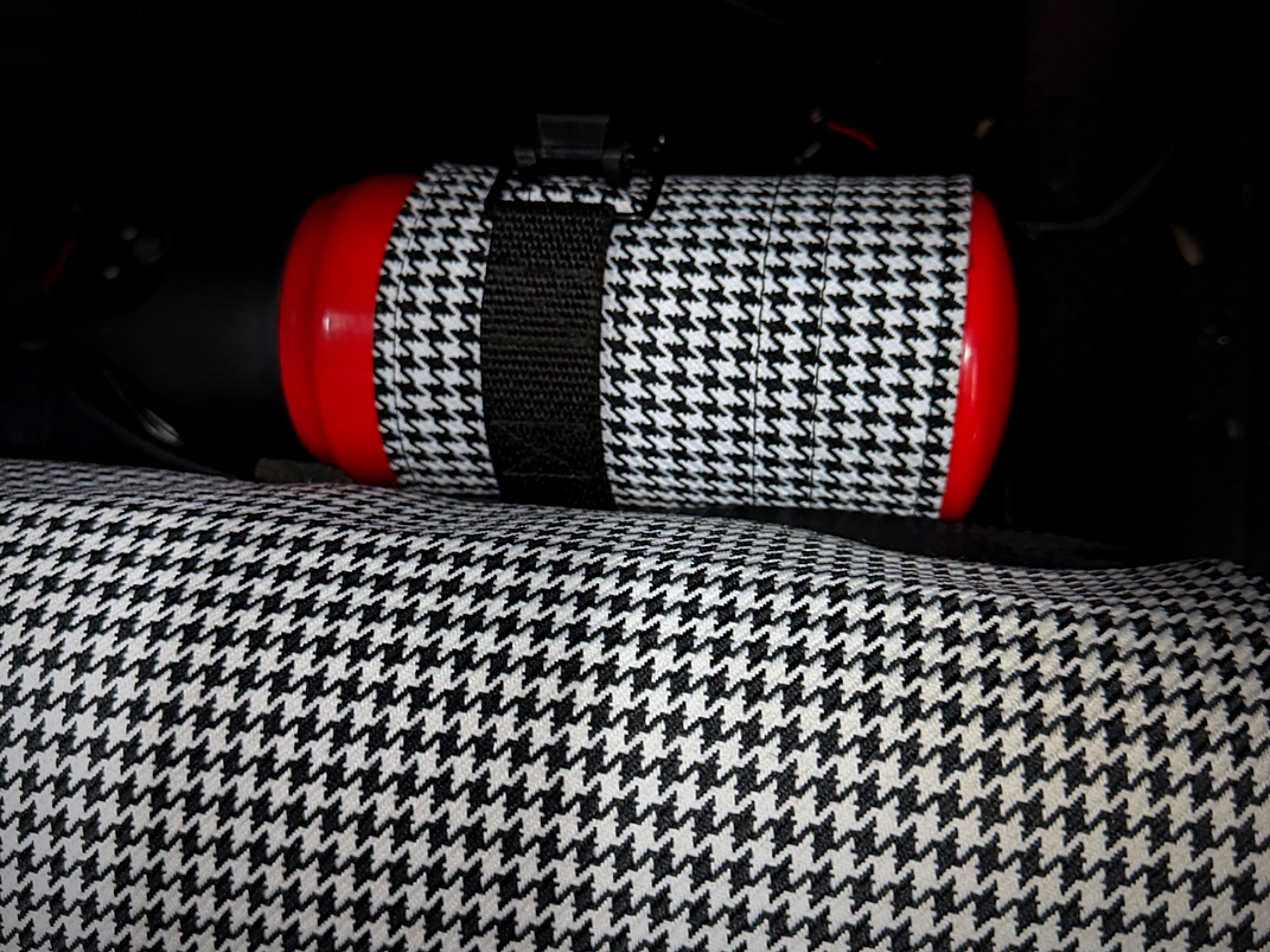 Houndstooth fire extinguisher cover for a Porsche