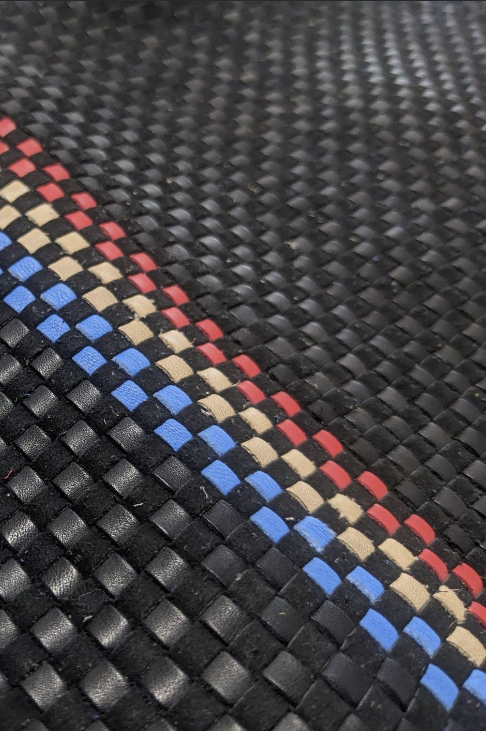 Hand-woven black leather with red, blue, and tan racing stripes